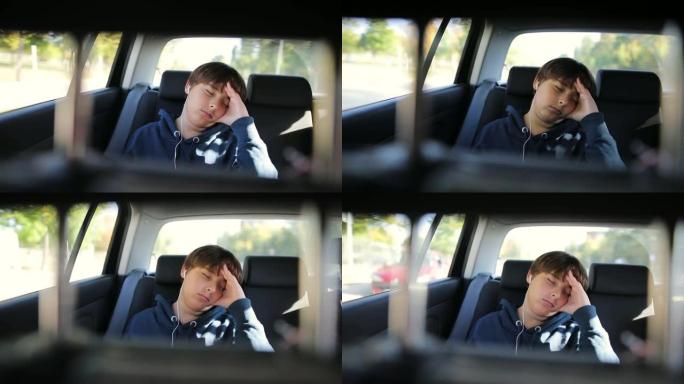 小男孩睡在没有安全带的车里