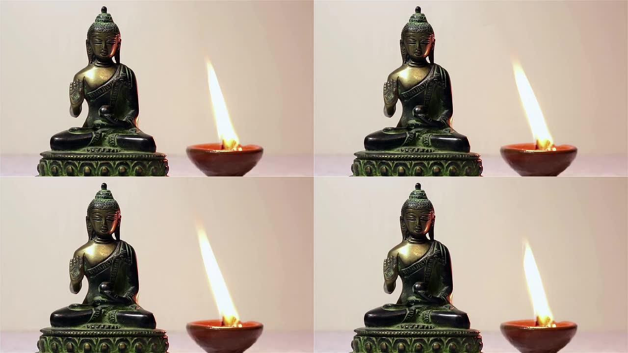 佛像和燃烧的蜡烛。