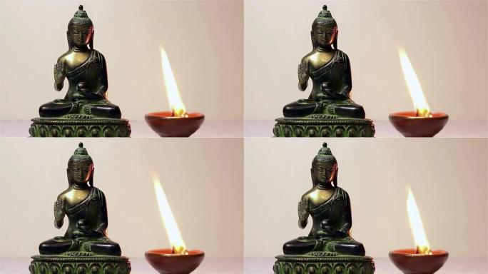 佛像和燃烧的蜡烛。