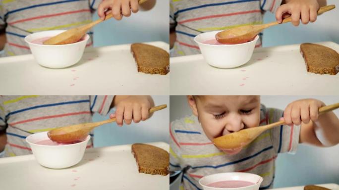 小男孩开胃吃美味的自制汤用大勺子