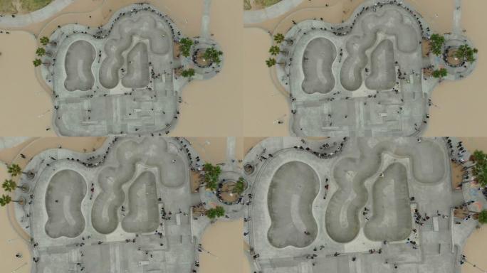 威尼斯海滩木板路上的4k空中视频滑板手