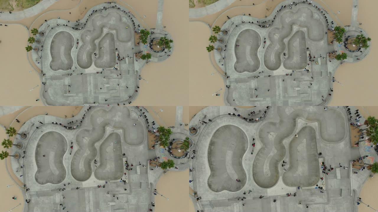 威尼斯海滩木板路上的4k空中视频滑板手