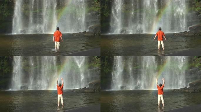 人与彩虹的热带瀑布