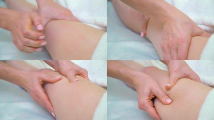 女性按摩师手在女性大腿上做消脂按摩的特写