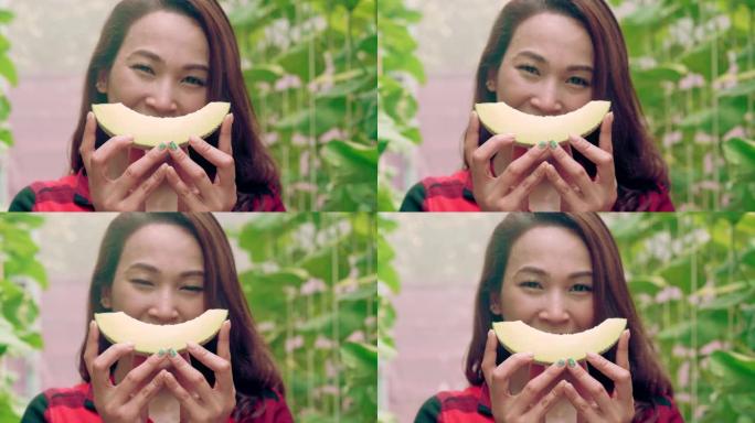 美丽的泰国女人主人一边微笑着带着积极的情感背着瓜