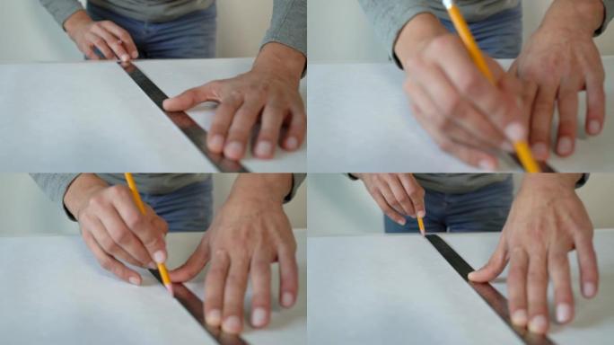 特写男性手准备新壁纸卷并用铅笔和尺子在室内桌子上标记