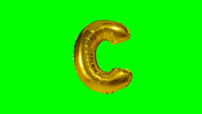 漂浮在绿色屏幕上的字母氦气黄金气球的大字母C
