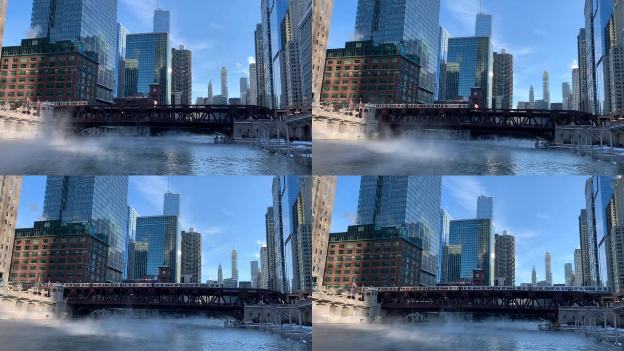 随着气温骤降，一辆高架的 “埃尔” 火车穿过一座桥，蒸汽从芝加哥河上升。