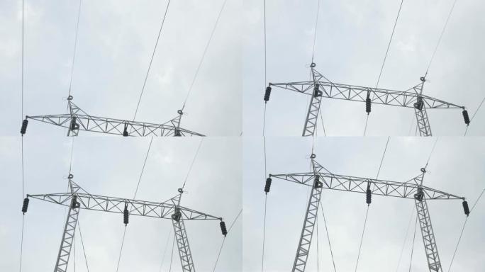 多云天空前的输电线路4K 2160p UHD慢倾斜镜头-输电杆金属结构和电线4K 3840x2160