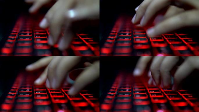 十几岁的黑客女孩在黑暗中攻击公司服务器，在红色照明的笔记本电脑键盘上打字。房间很暗