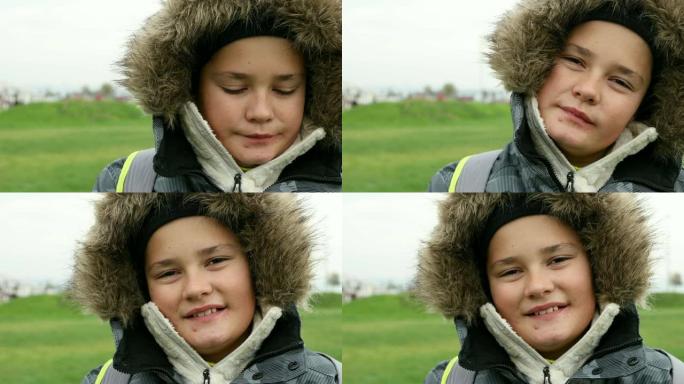 一个英俊的青春期男孩在冬季户外的肖像