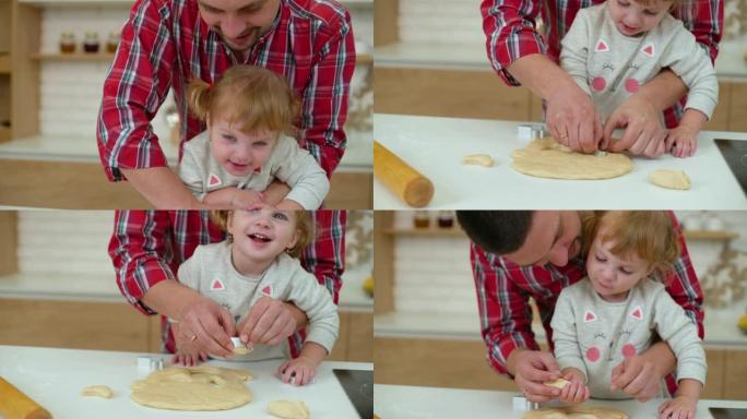 可爱的小女孩和她的父亲一起做饼干