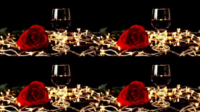 在明亮的花环的背景下，酒杯和玫瑰。