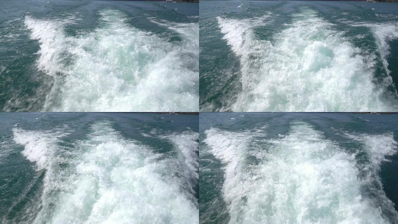 从旅客渡轮的后视图拍摄的4k视点跟踪照片，该渡轮在台湾日月潭挥舞着鲜亮的绿色水，并溅起泡沫。