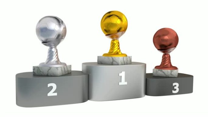 在领奖台上无限旋转的带有大理石底座的金银和青铜足球奖杯