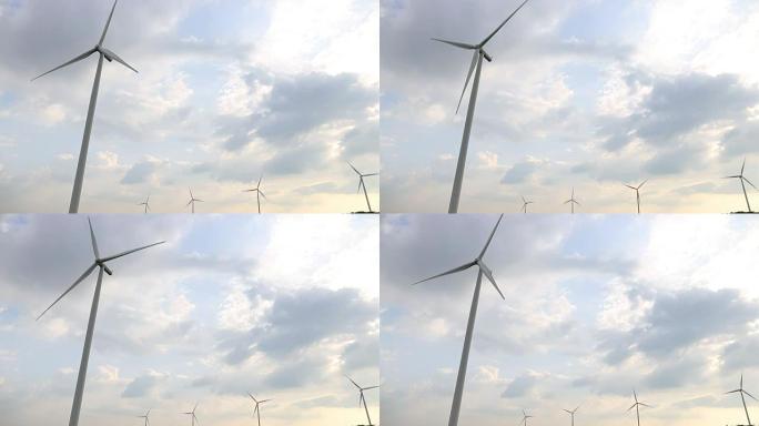 风力涡轮机发电与天空太阳和云背景。