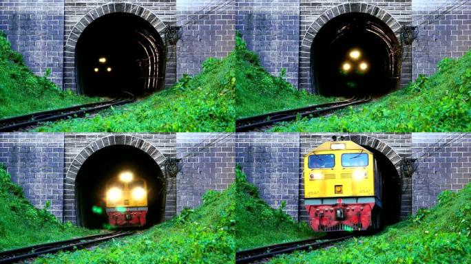 慢动作火车在吹风的情况下打开了从旧隧道行驶的前灯。古铁路隧道前山脚的绿草。