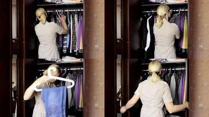 年轻的金发女人站在家里打开的衣柜前，选择衣服穿衣服