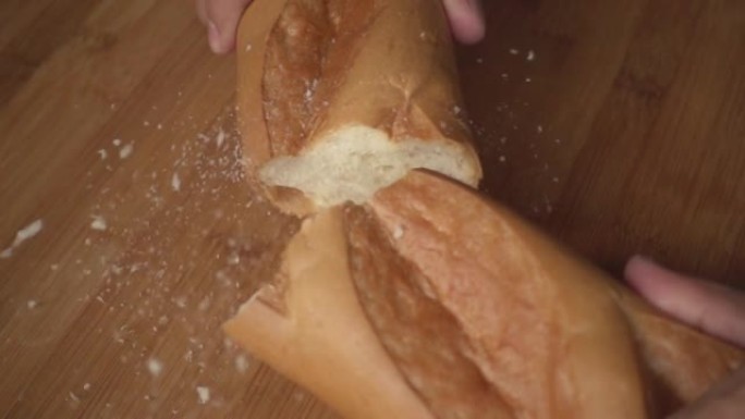 男子在慢动作中摔碎了一半的法国法式面包