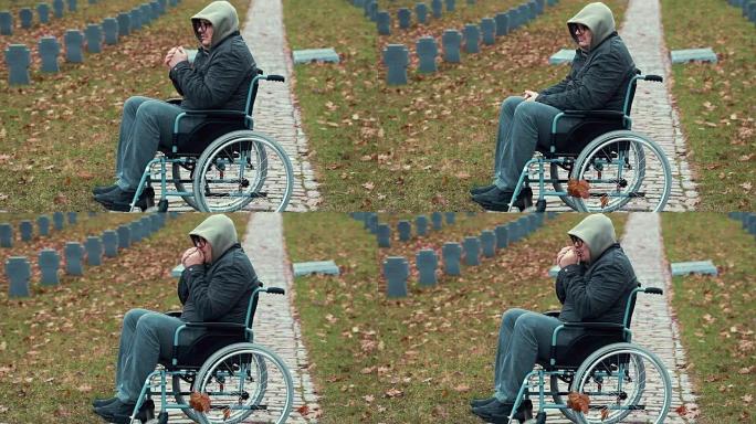 秋天，在公墓里，坐在轮椅上的孤独残疾老兵