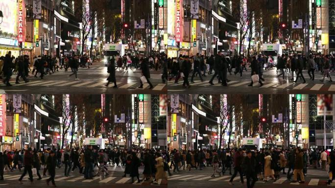 行人在日本东京涩谷路口夜间穿越
