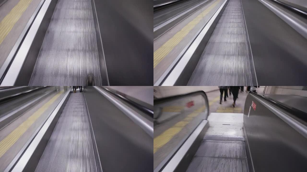 摄影师在土耳其伊斯坦布尔地铁的自动人行道上行走