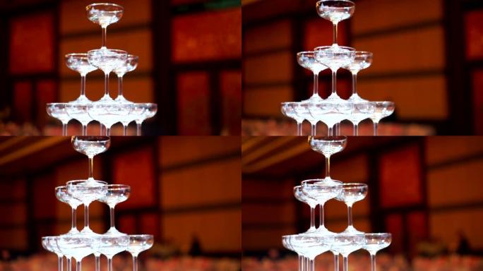 CU Dolly right: 婚礼仪式中金字塔空的香槟杯，用于浇注背景模糊的香槟。