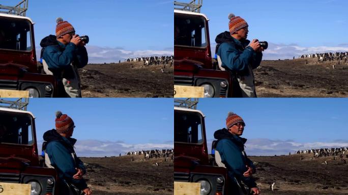摄影师在南极洲西点岛拍摄背景中的企鹅照片