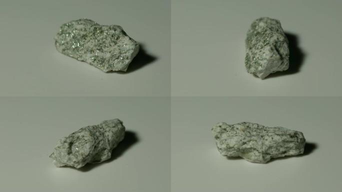 白色背景旋转的片麻岩矿物样品
