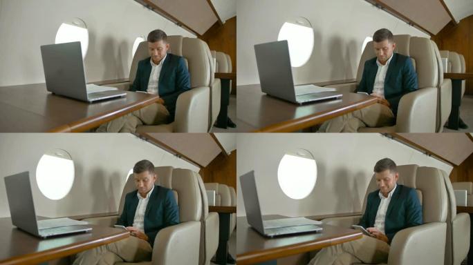 商人坐在私人飞机机舱舒适的扶手椅上聊天