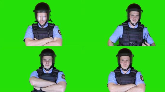 警察戴着头盔，身穿防弹衣，背景是绿色