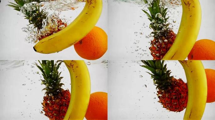 橘子，菠萝和香蕉在水中以慢动作旋转的气泡旋转。