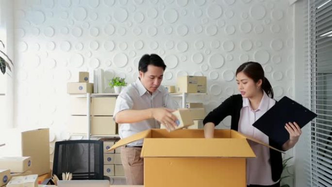 中小企业概念男女工人在办公室包装包装箱