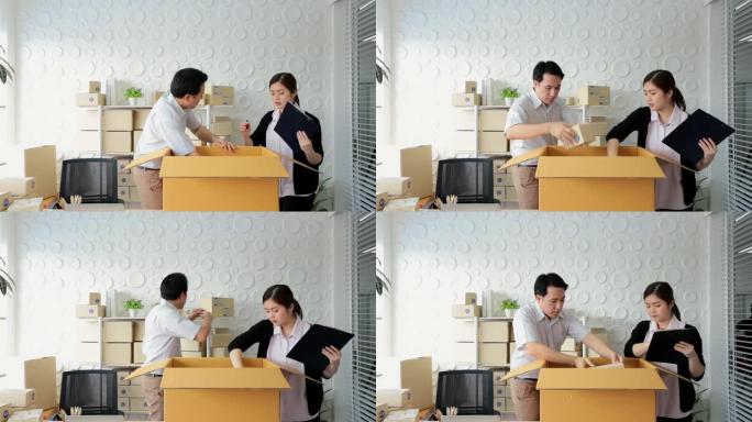 中小企业概念男女工人在办公室包装包装箱