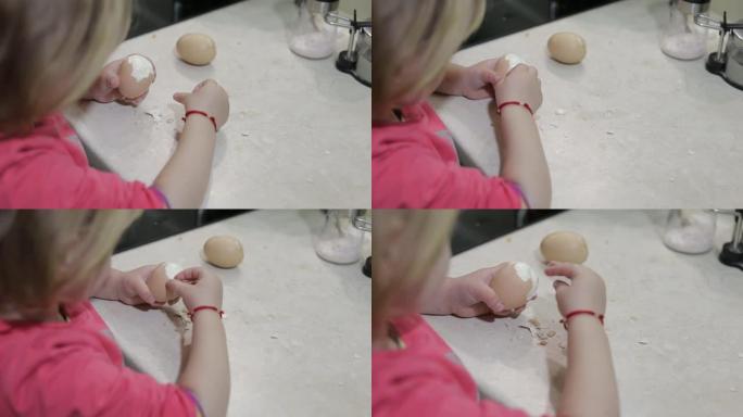 一个小女孩的特写镜头用煮熟的鸡蛋清洗外壳