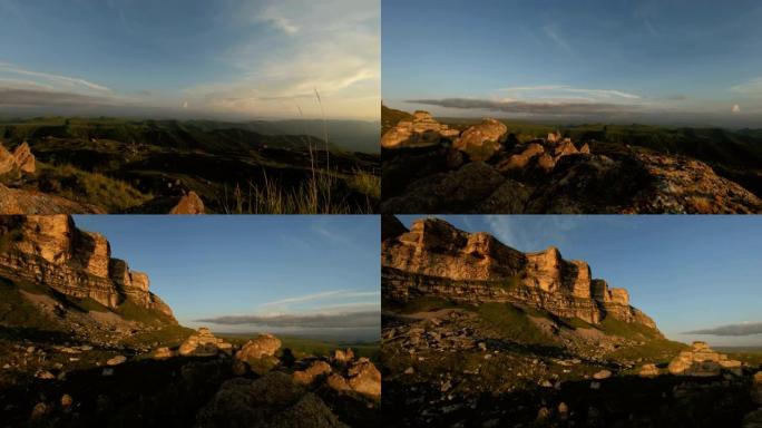 低矮的落日天空在岩石山谷中云密布。日落时岩石块脚下的地形全景。4k暖灯