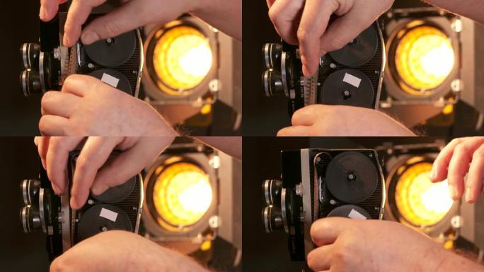 男子拍摄与老式8毫米电影摄影机。将胶卷装入相机