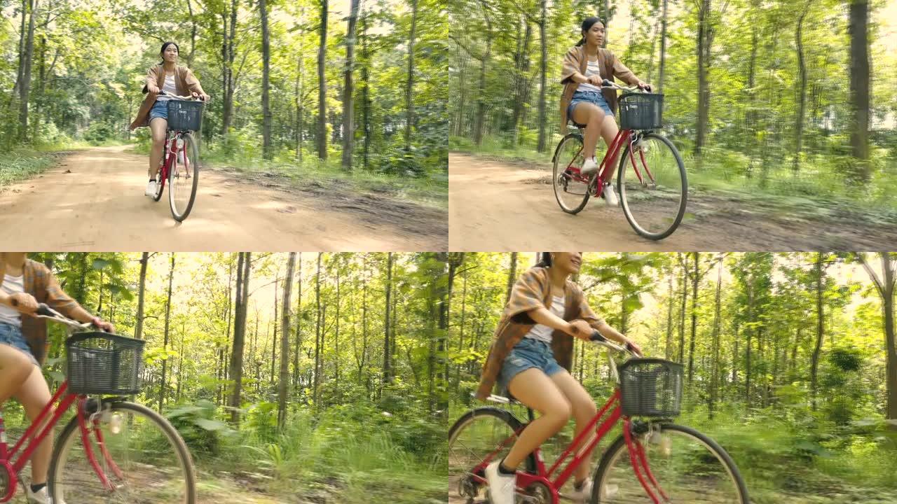 美丽的亚洲女孩骑自行车享受泰国乡村森林旅行