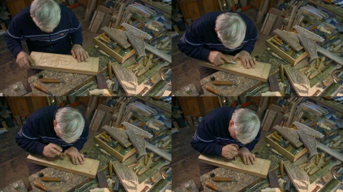 木雕师正在雕刻橡木木板。