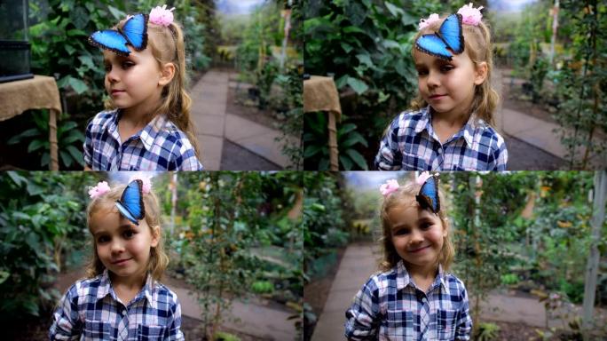 女孩的头上坐着一只美丽的蓝色蝴蝶。女孩正看着镜头，微笑着。4k慢速移动