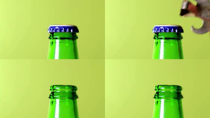 一只手在绿色的背景上打开一瓶绿色的啤酒。