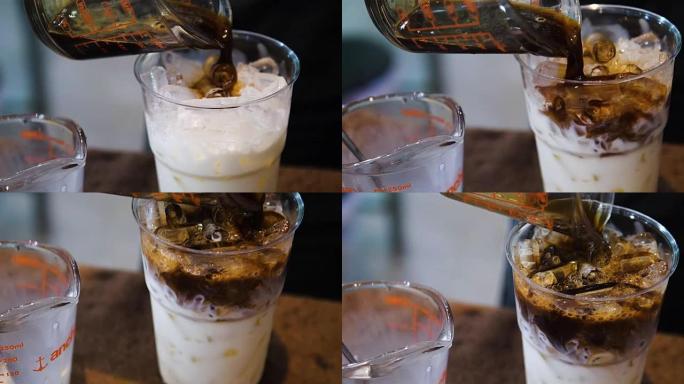 泰国PRACHUBKIRIKHAN-2018年7月7日: 将咖啡倒入一杯冰中，慢动作。