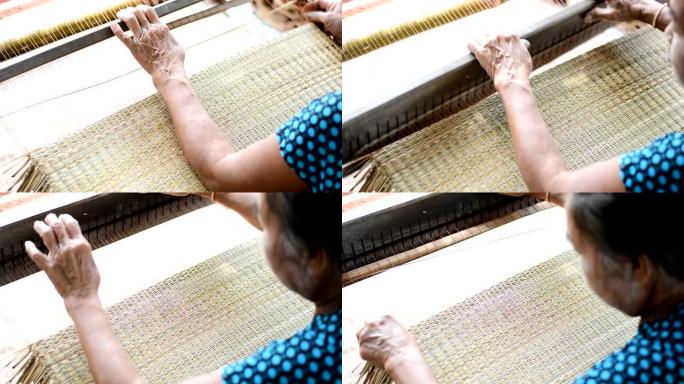 亚洲妇女用干莎草纸编织典型的泰国草席
