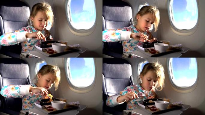 孩子在飞机上吃健康午餐。