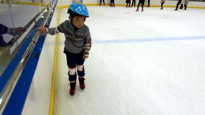亚洲男孩在室内学习滑冰