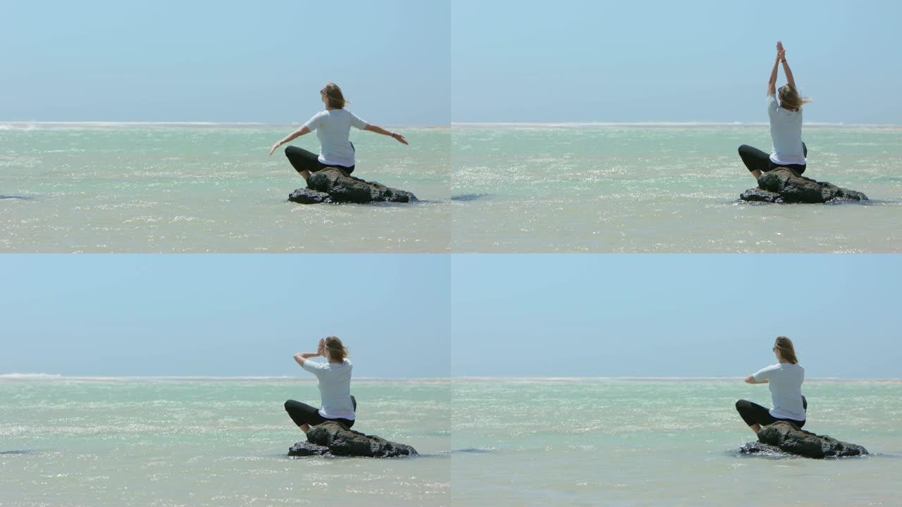金发女人在做瑜伽练习，风筝冲浪者在后台冲浪