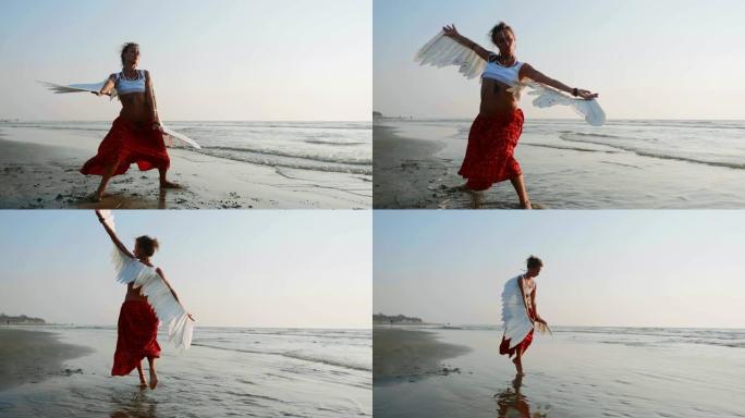 带着天使翅膀的年轻女孩在日落时跳舞