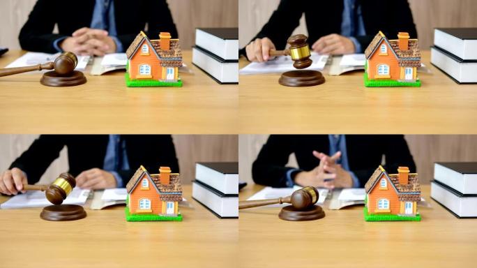 律师在法庭上用房屋模型敲打法官木槌。房地产纠纷 & 房产拍卖概念