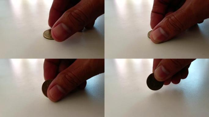 男性手在街道地板上保管钱币，以求运气或储蓄概念慢动作