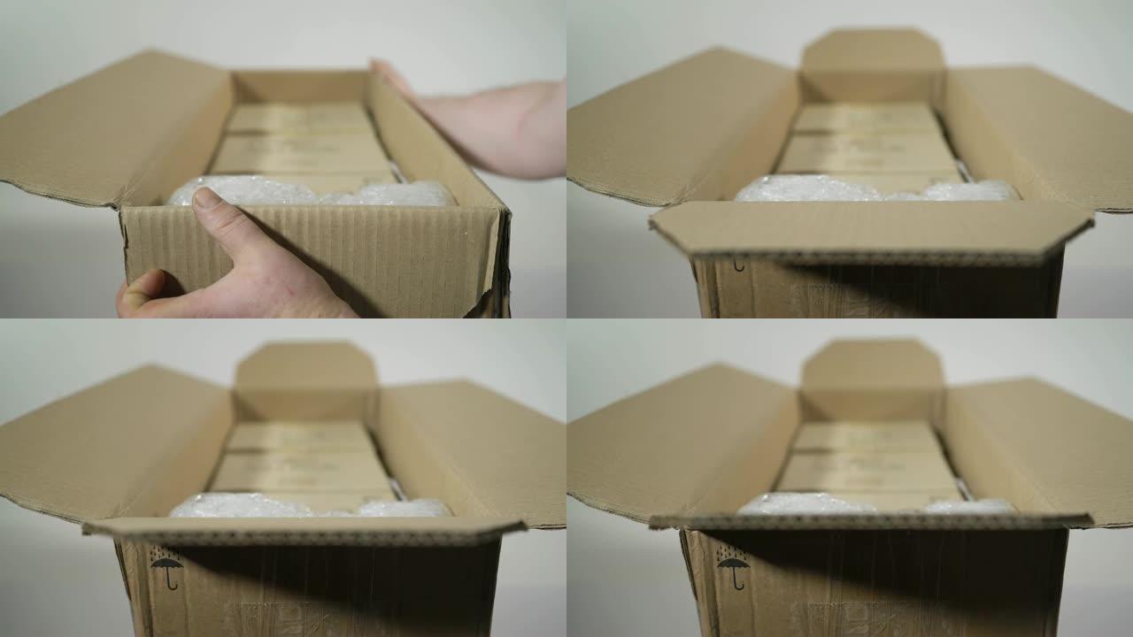 男子打开包裹纸板箱